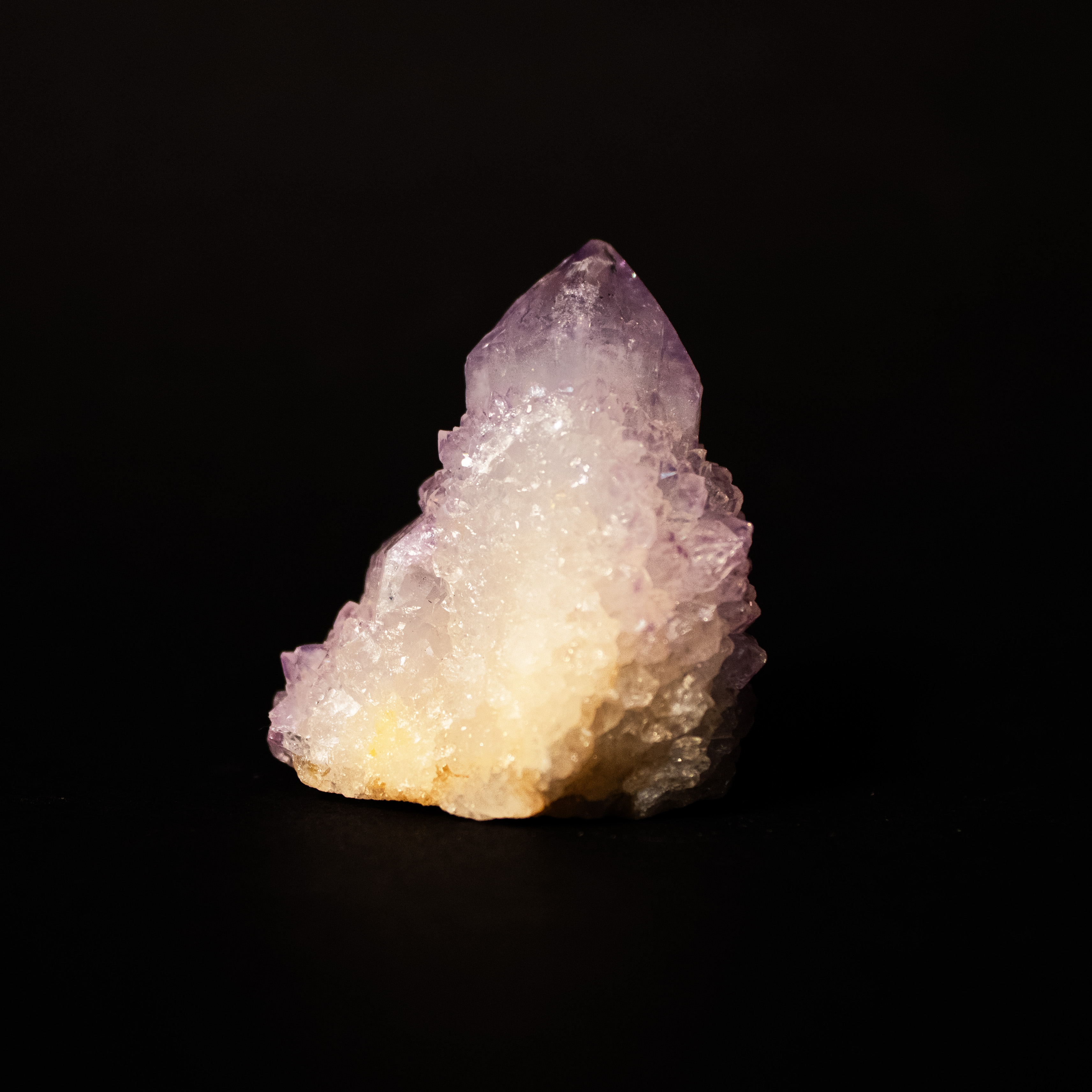 purple and white spikey gemstone that comes to a point at top